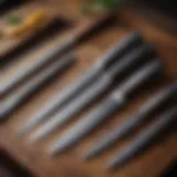 A collection of different types of culinary knives laid out on a wooden surface