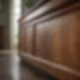 A close-up of a wooden cabinet surface with grease stains