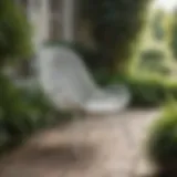 Elegant white woven outdoor chair in a serene garden setting